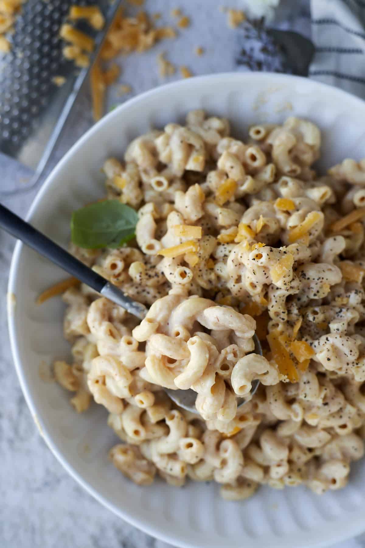 a bowl of crockpot mac and cheese with a spoon dipping in.