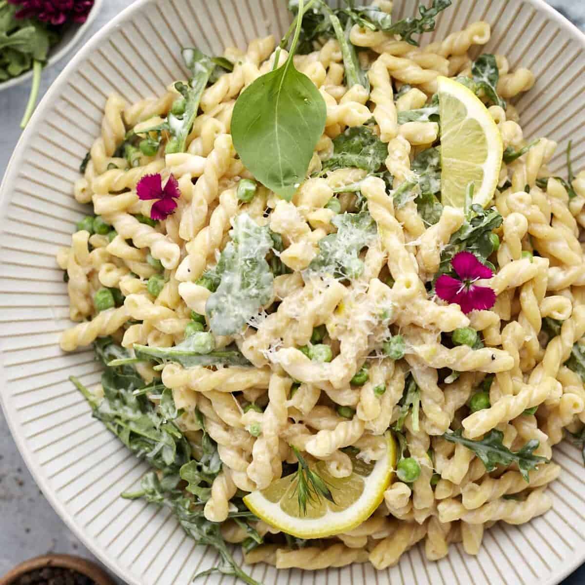 overhead image of a white bowl of lemon ricotta pasta
