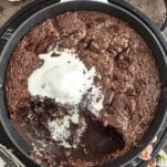 overhead image of a chocolate hazelnut skillet brownie topped with vanilla ice cream