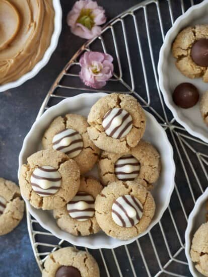 overhead image of bowls of peanut butter blossoms on a wire rack.