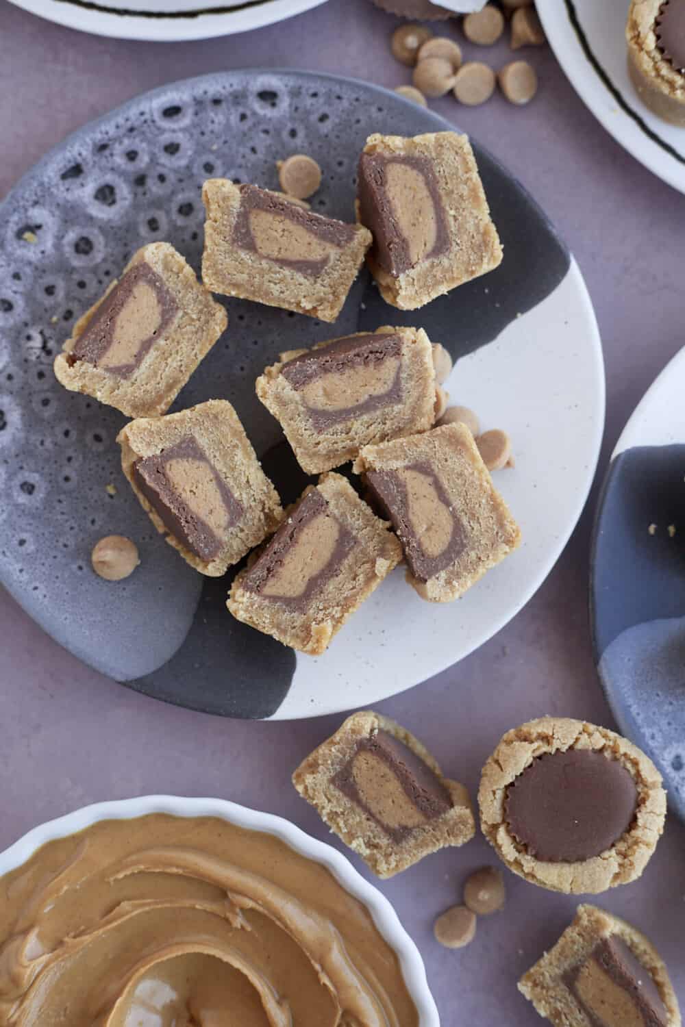 overhead image of a plate full of Reese's peanut butter cup cookies sliced in half 