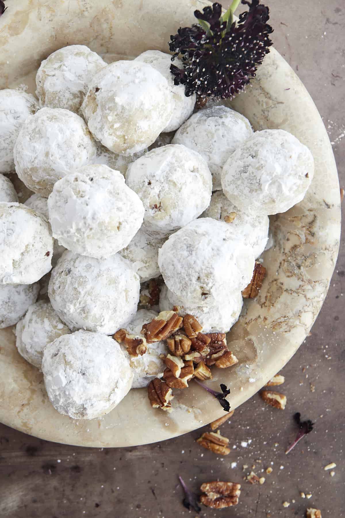 A bowl of pecan snowball cookies.