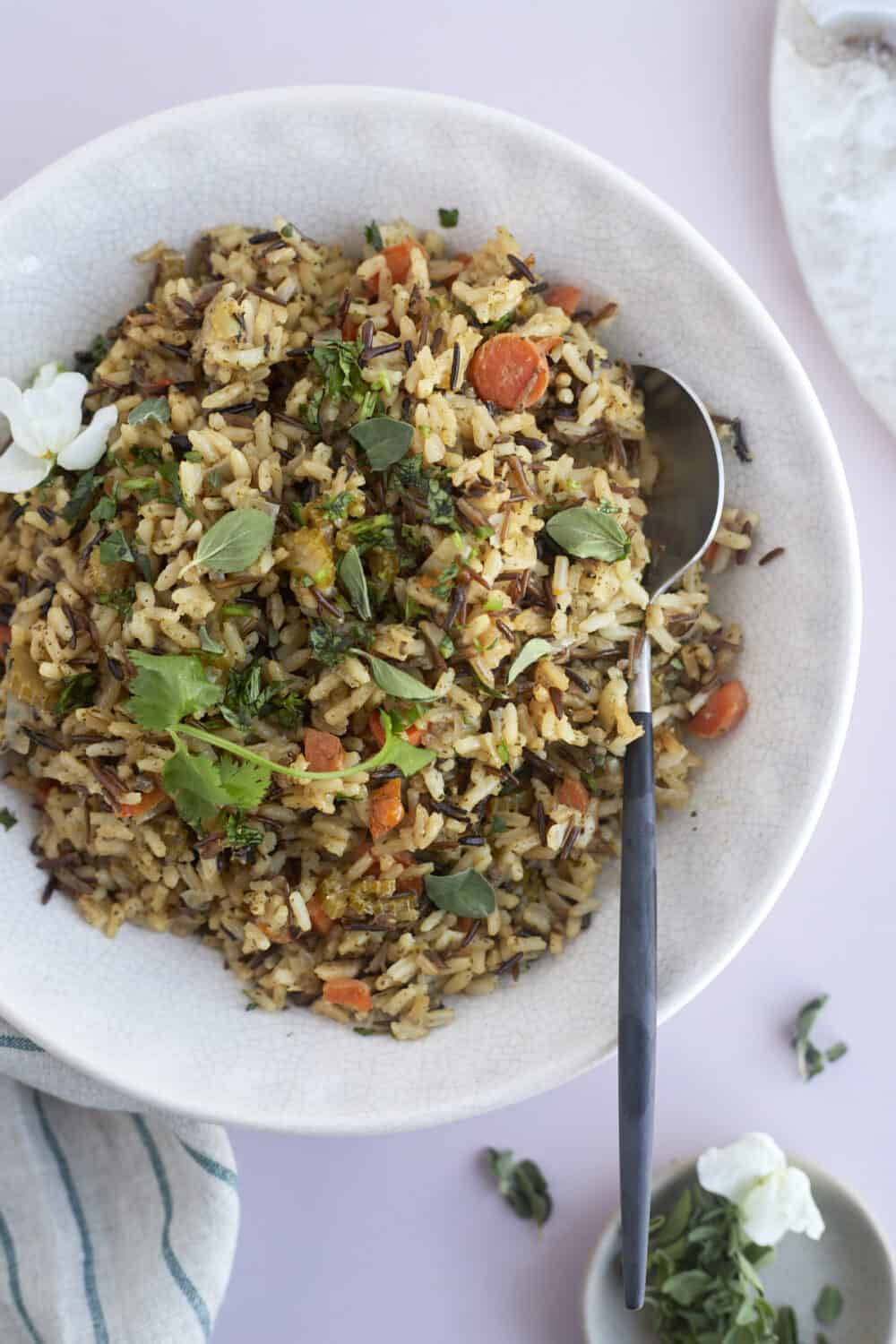overhead image of a bowl of easy seasoned rice pilaf with a spoon on the side