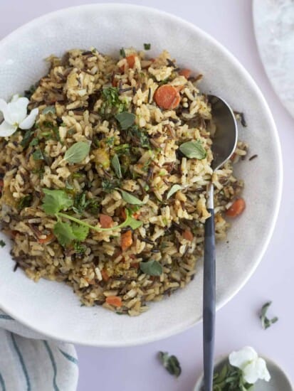 overhead image of a bowl of easy seasoned rice pilaf with a spoon on the side
