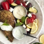 overhead image of a bowl of za'atar chicken with vegetables.