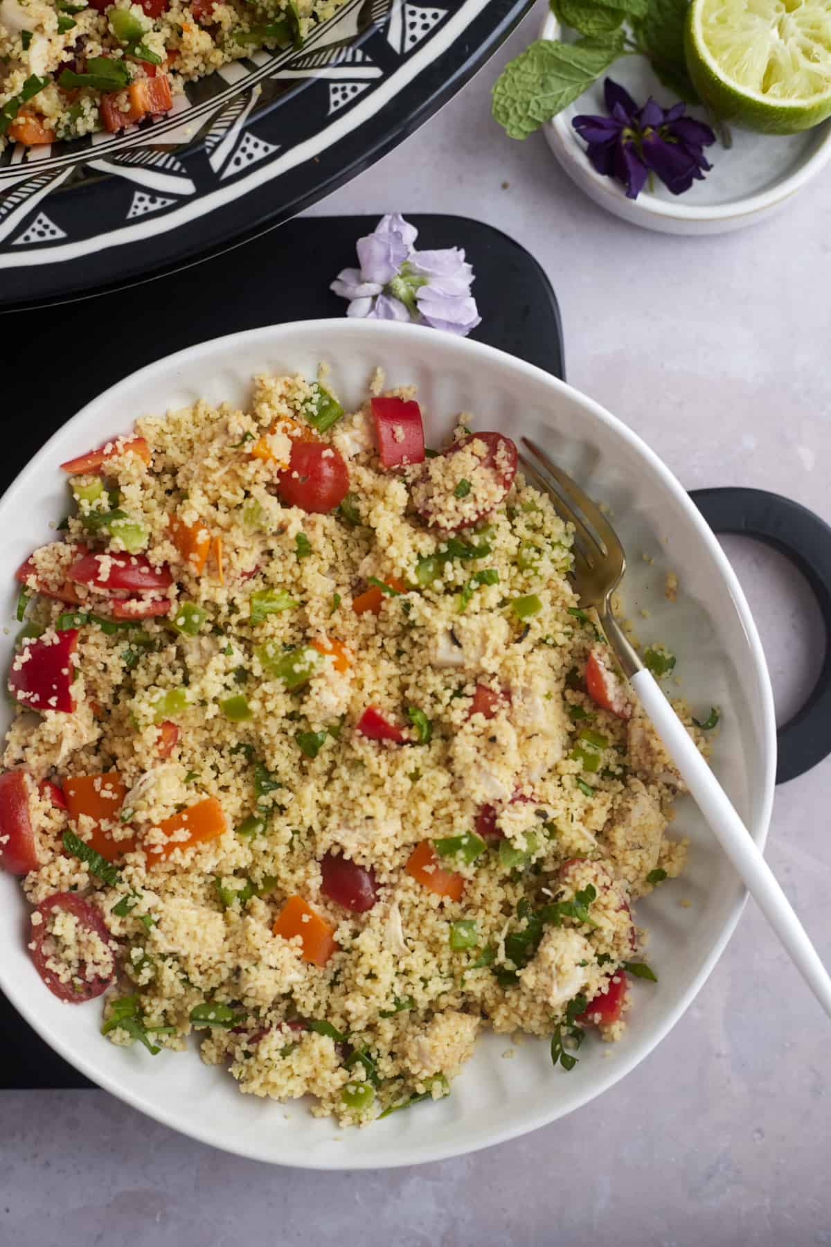 a bowl of couscous salad with chicken