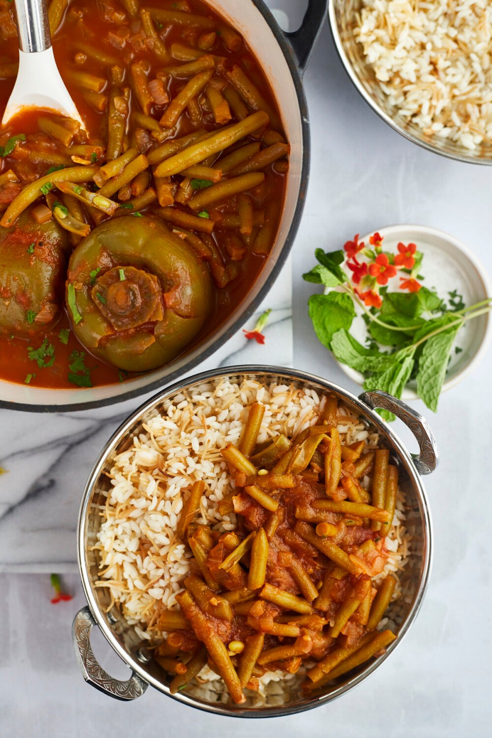 a pot of fasooliya and a side of green bean stew over rice