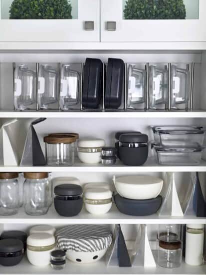 A cabinet full of organized food storage containers.