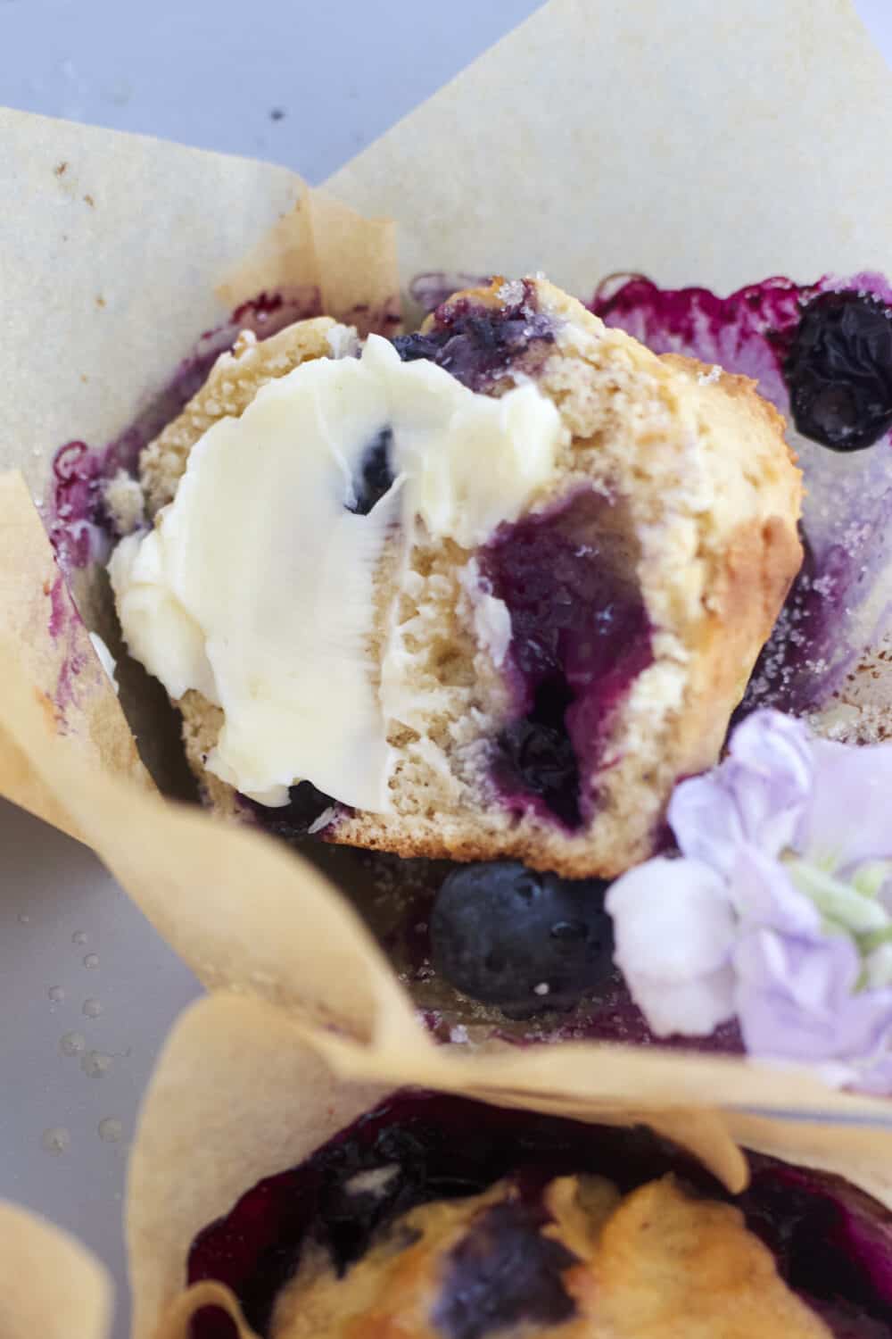 half a blueberry muffin with butter on top