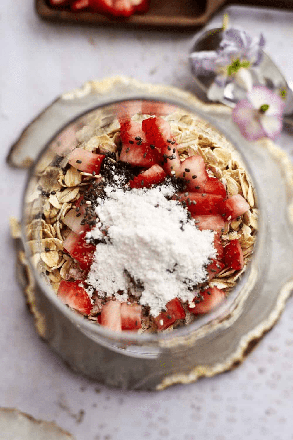 oats and strawberries topped with chia seeds and sweetener