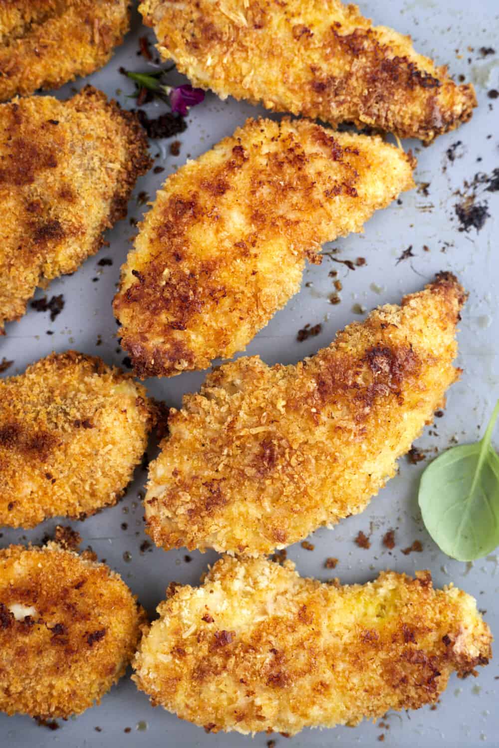 oven-baked parmesan chicken tenders on a baking sheet