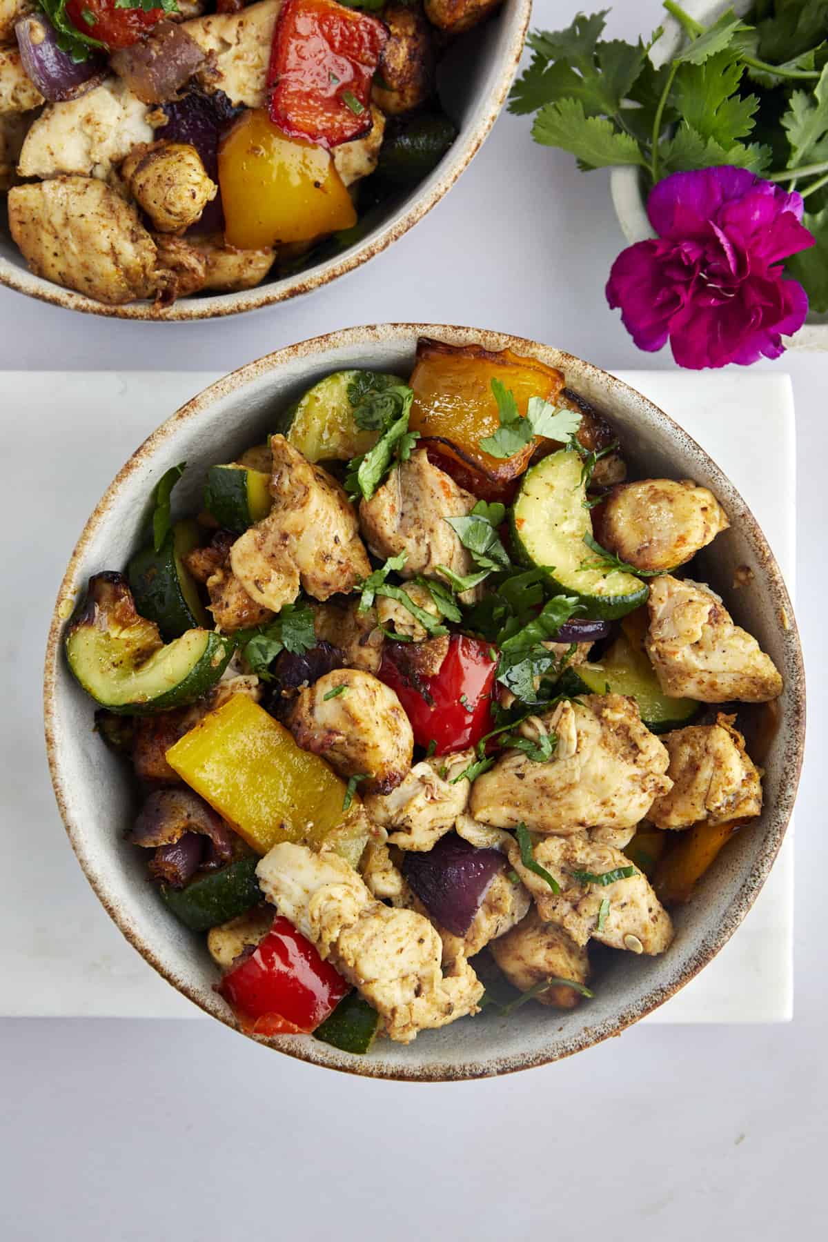 two bowls of air fryer chicken breast with vegetables