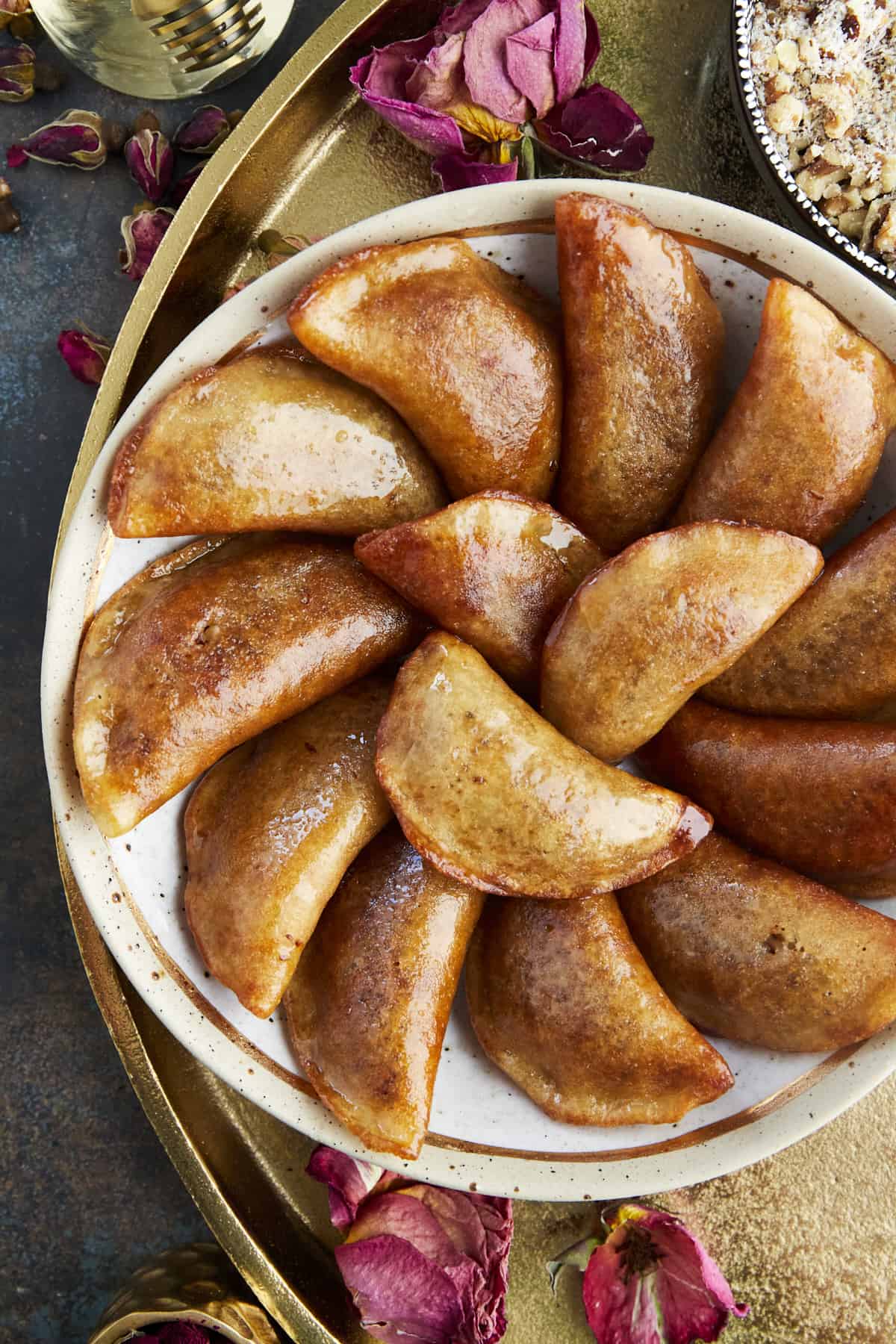a plate of qatayef that have been dipped in simple syrup