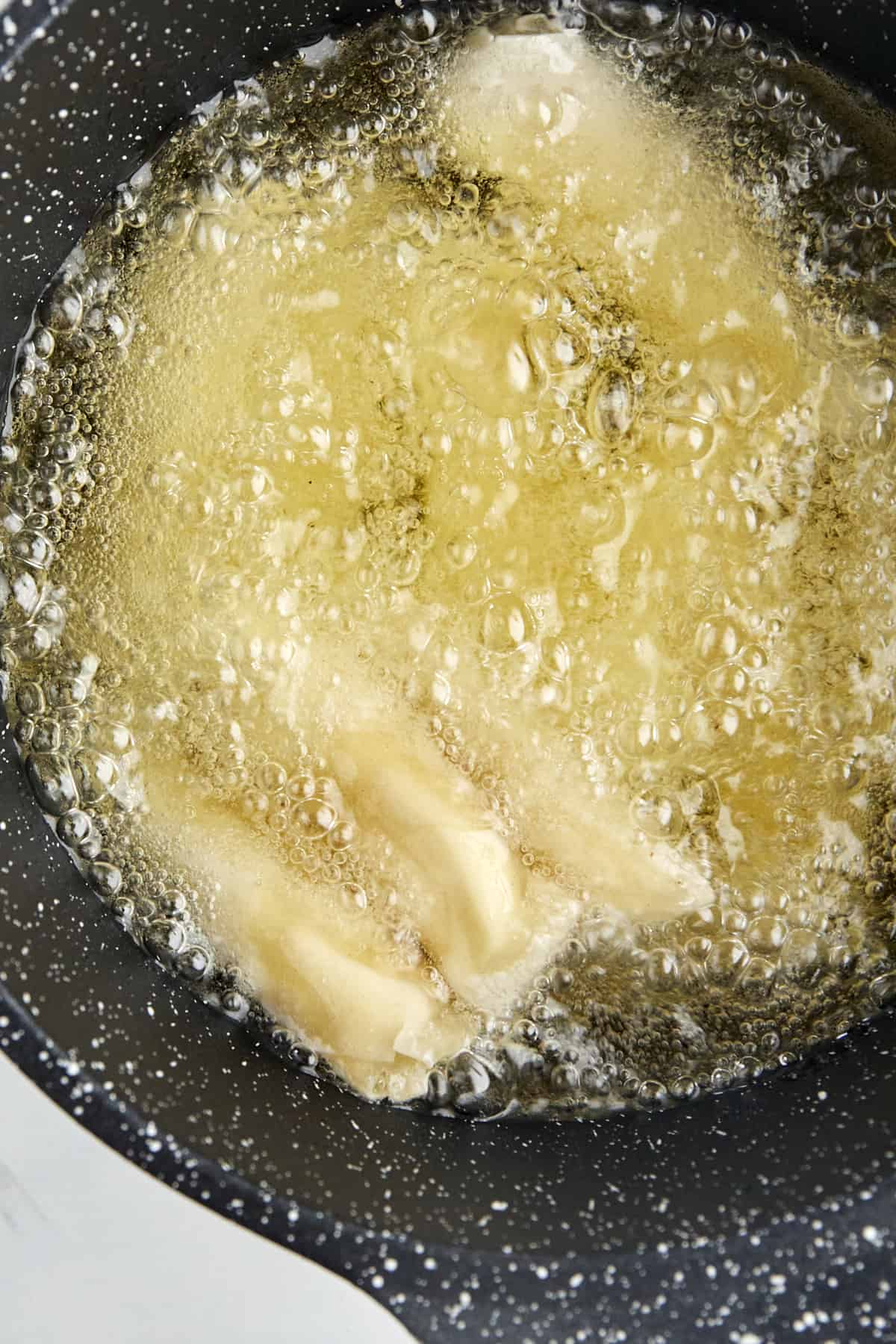 feta rolls frying in oil
