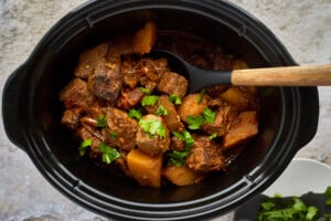 Cooked Middle Eastern beef stew in a crockpot.