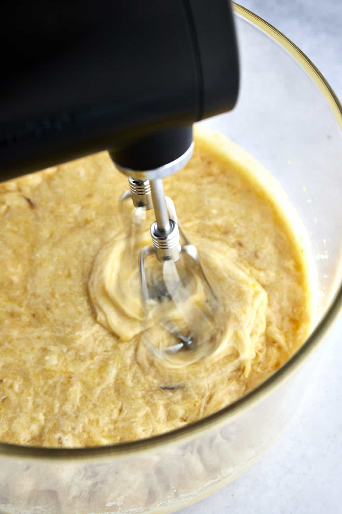 a hand mixer beating one bowl banana bread batter