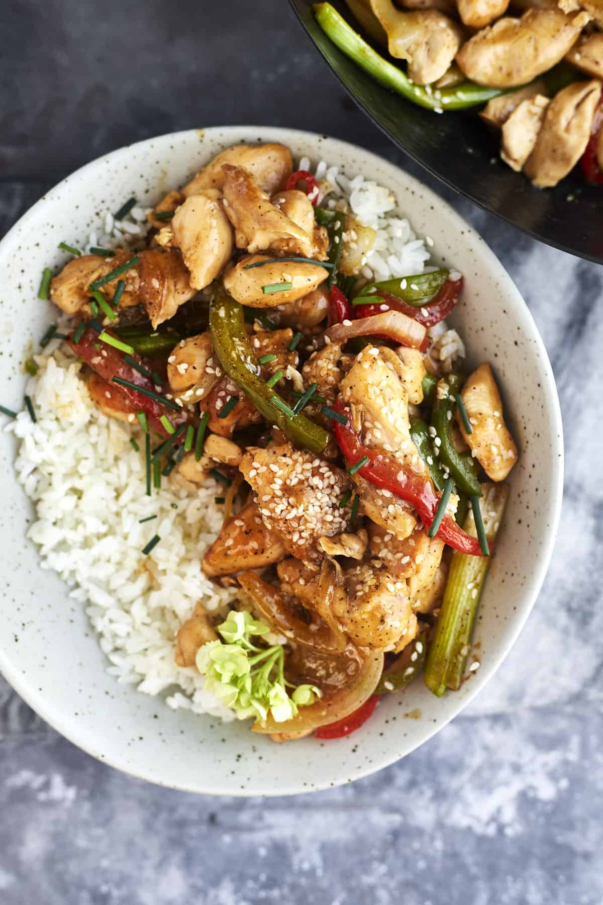 a bowl of white rice topped with black pepper chicken