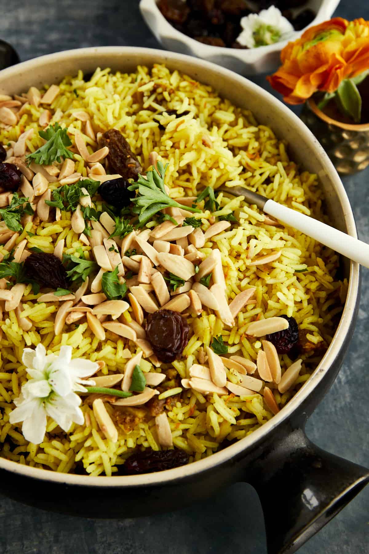 a pot of Persian jeweled rice with chopped nuts, dried fruit, and fresh herbs
