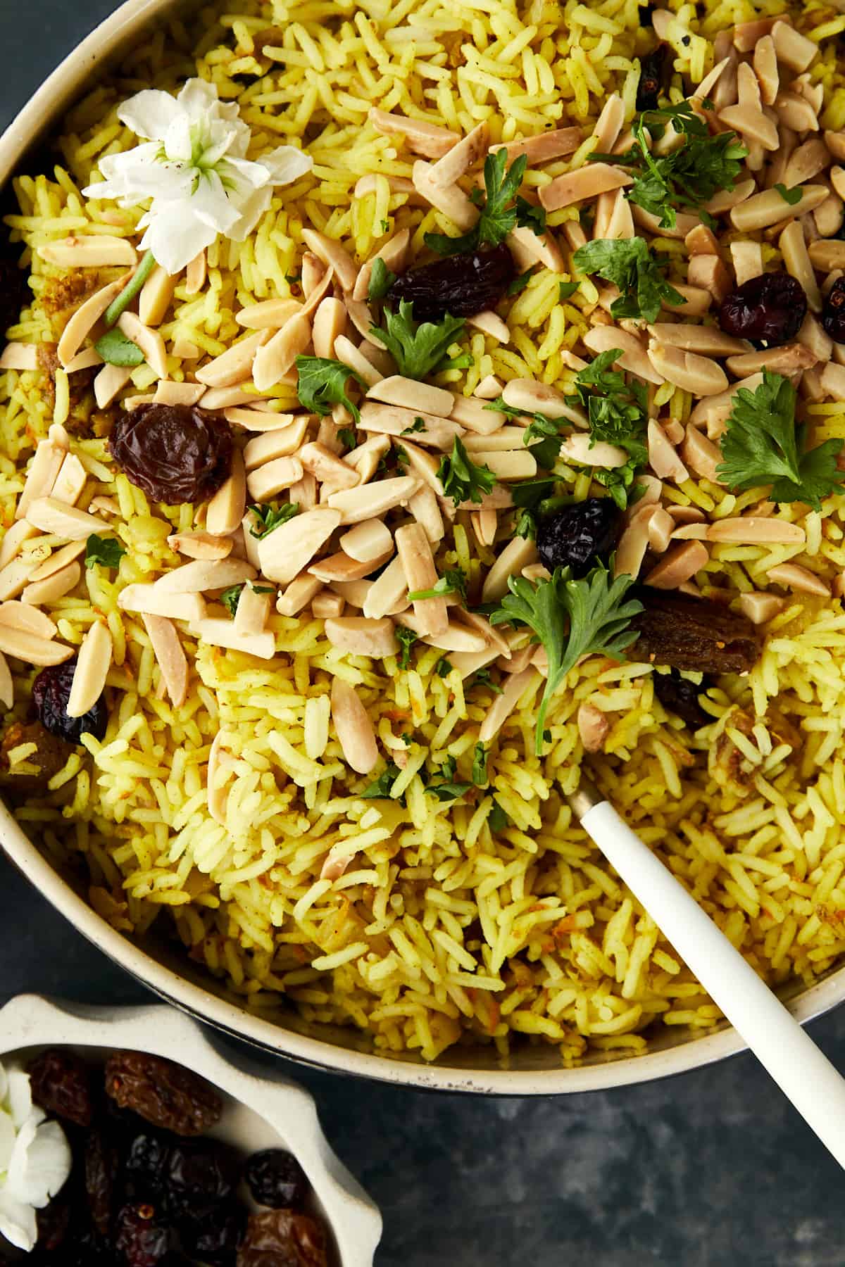 close up image of Persian jeweled rice topped with dried fruit, nuts, and herbs