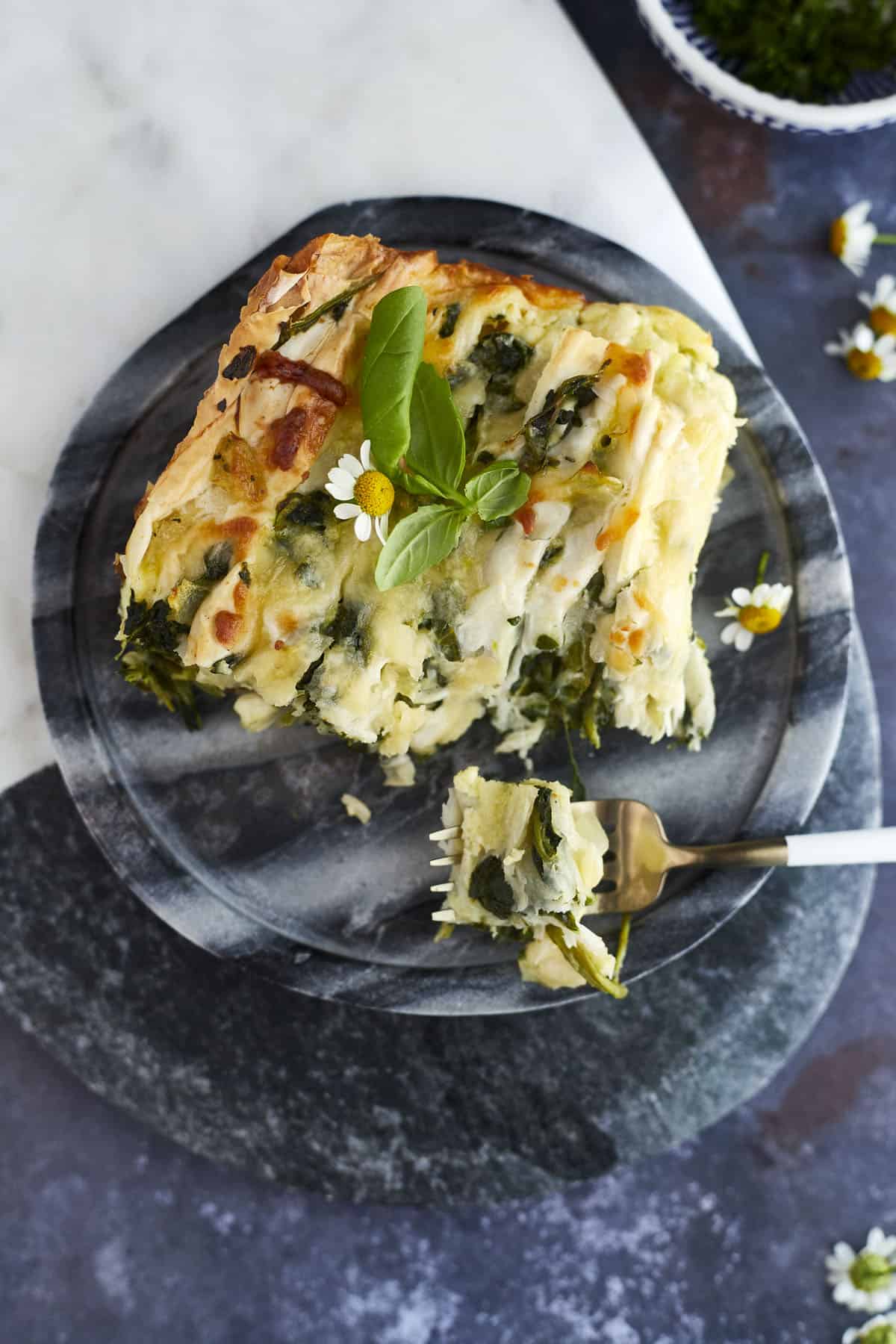 overhead image of a slice of savory crinkle phyllo with a fork with a bite on the side