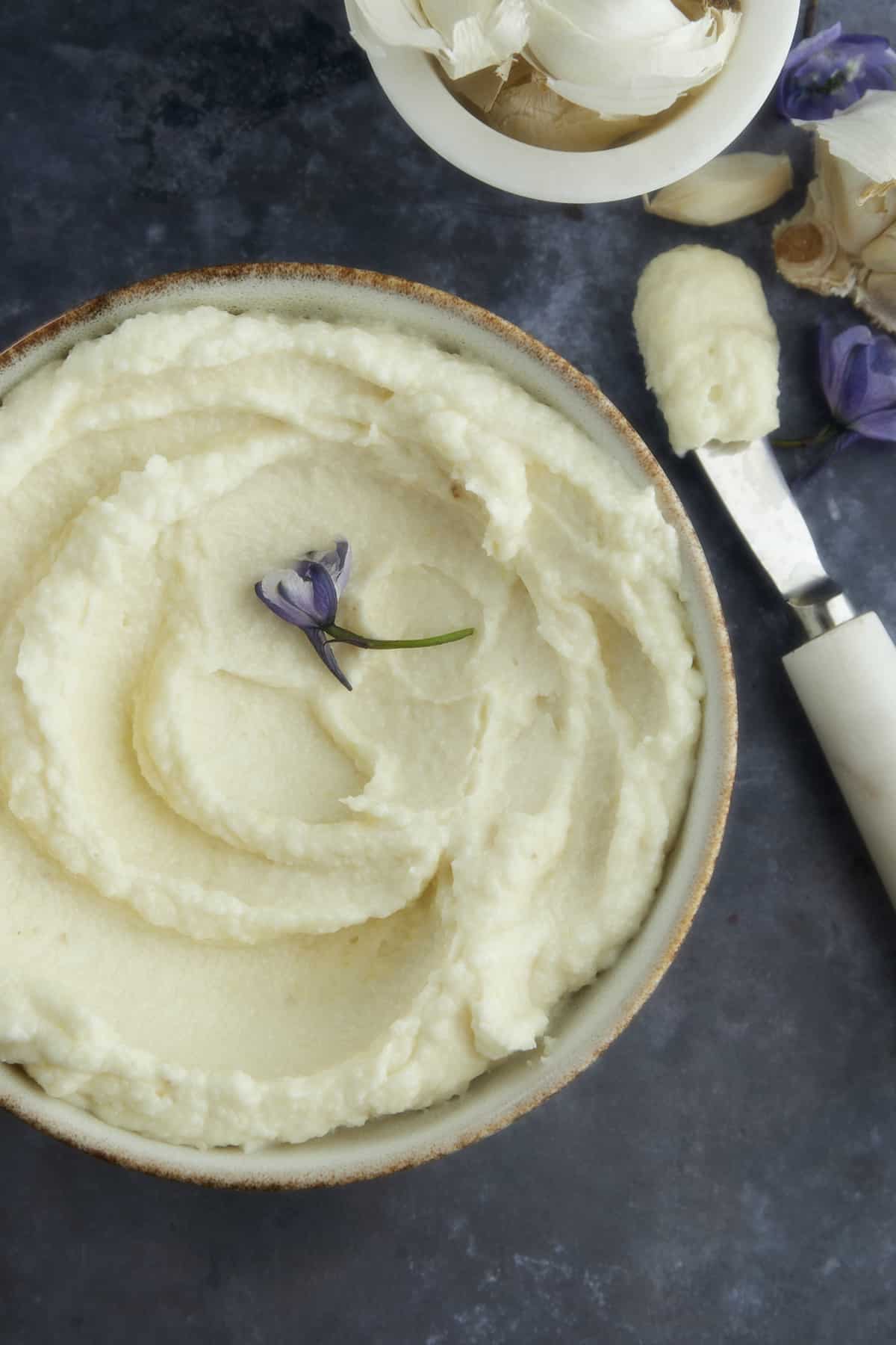 Lebanese garlic sauce with a spreader next to it