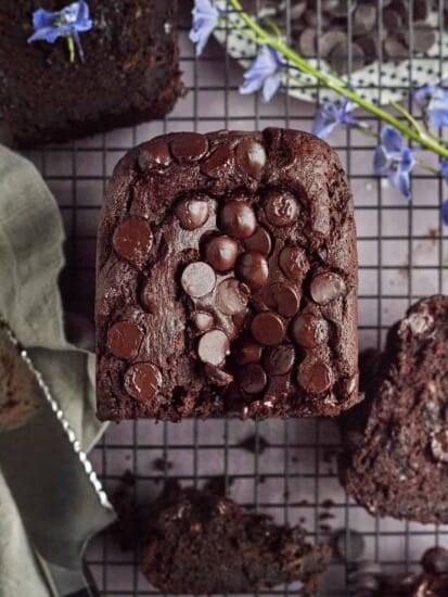 half a loaf of double chocolate banana bread on a wire rack