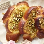 A serving of Baklava Challah French Toast on a white plate.