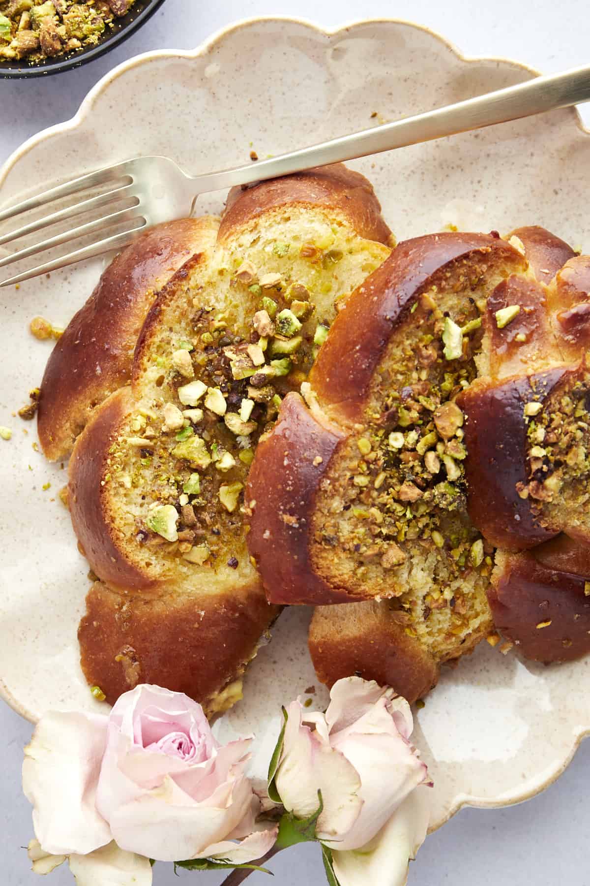 A serving of Baklava Challah French Toast on a white plate. 
