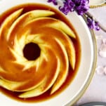 Creme caramel topped with caramel on a plate.