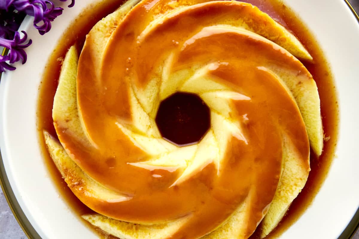 Overhead image of creme caramel flan on a plate. 