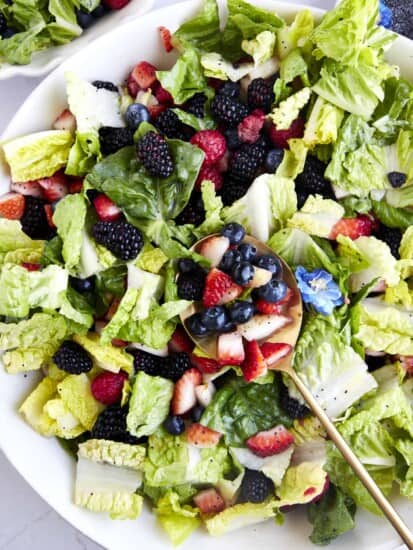 Overhead image of a summer berry salad tossed with poppy seed dressing.