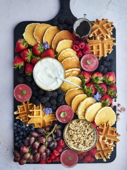 Overhead image of a breakfast charcuterie board with pancakes.
