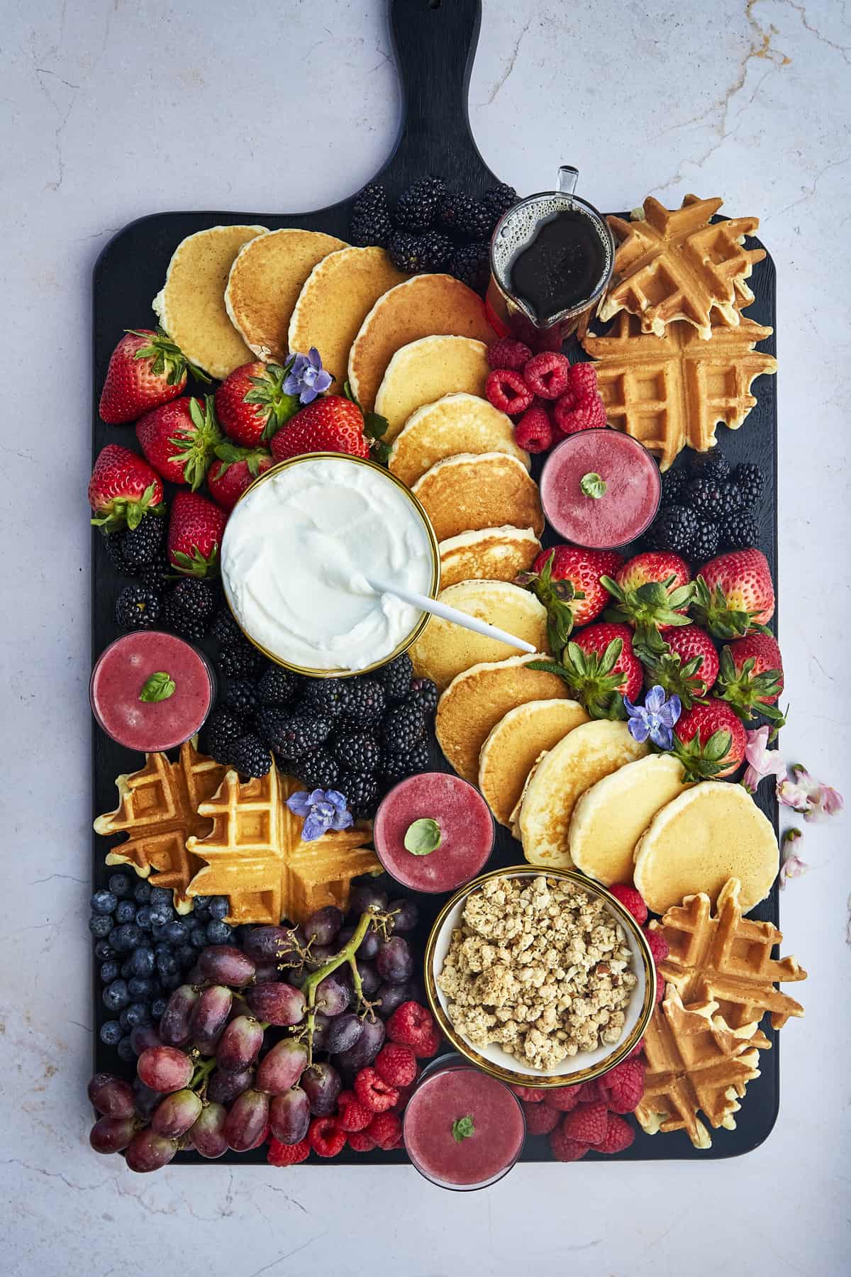 Overhead image of a breakfast charcuterie board with pancakes. 