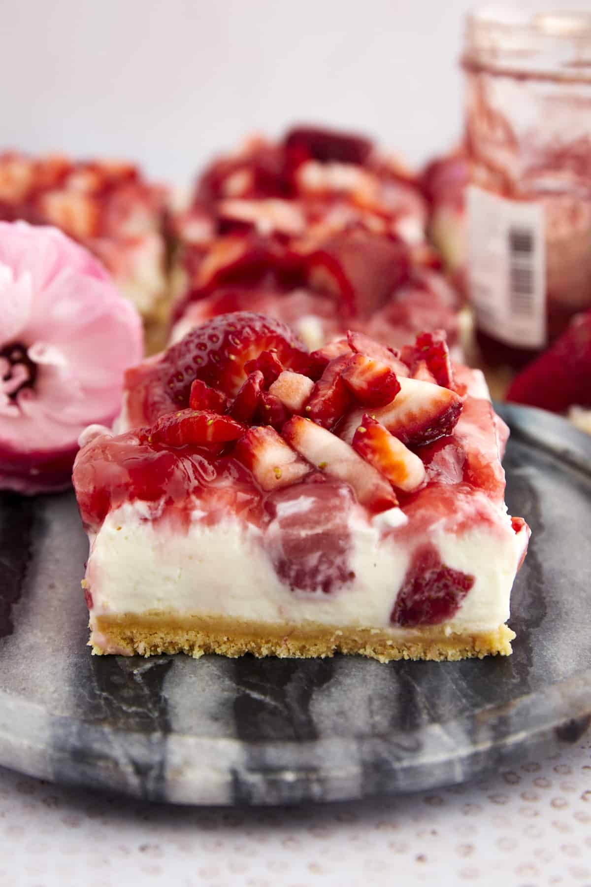 A side view of a strawberry cheesecake bar.