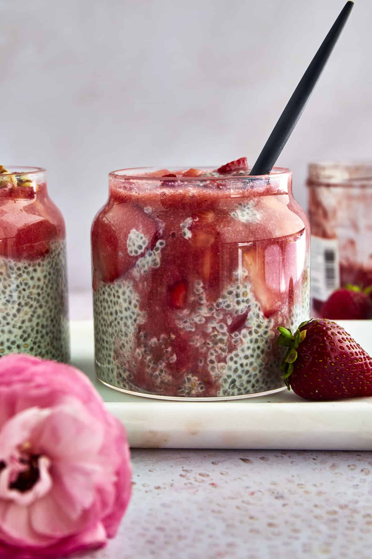 A jar of strawberry chia pudding with strawberry puree mixed in. 