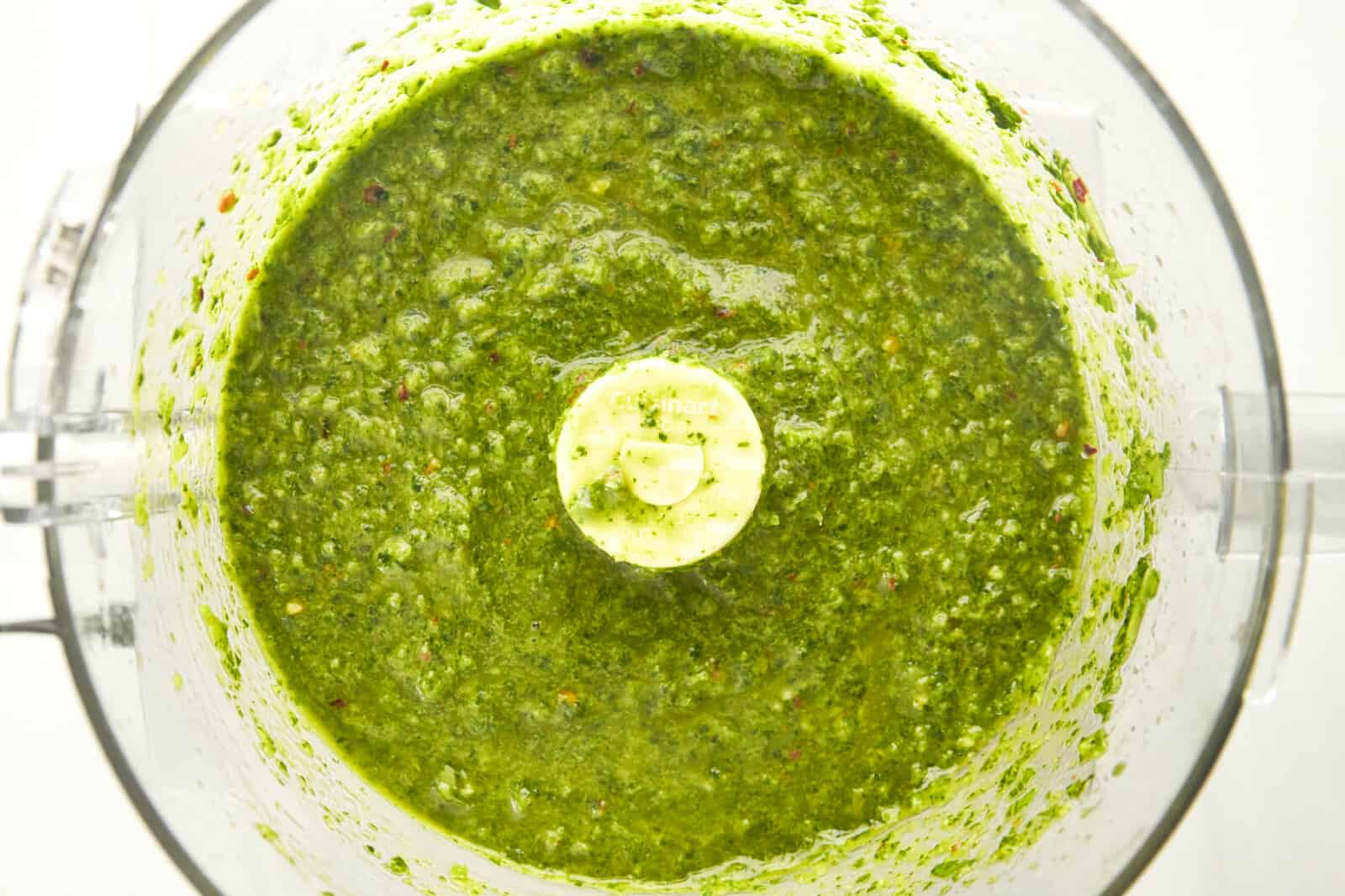 Overhead image of zhoug sauce in a food processor.