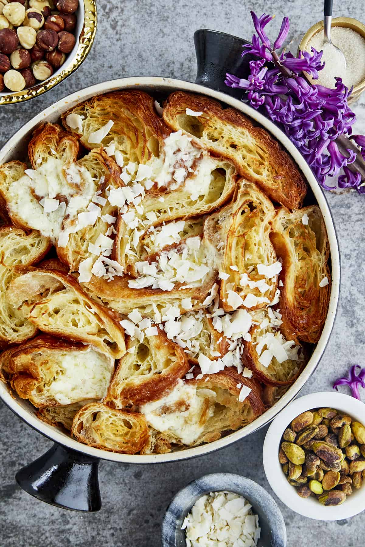 overhead image of a pan of yawmiyat om ali topped with coconut flakes