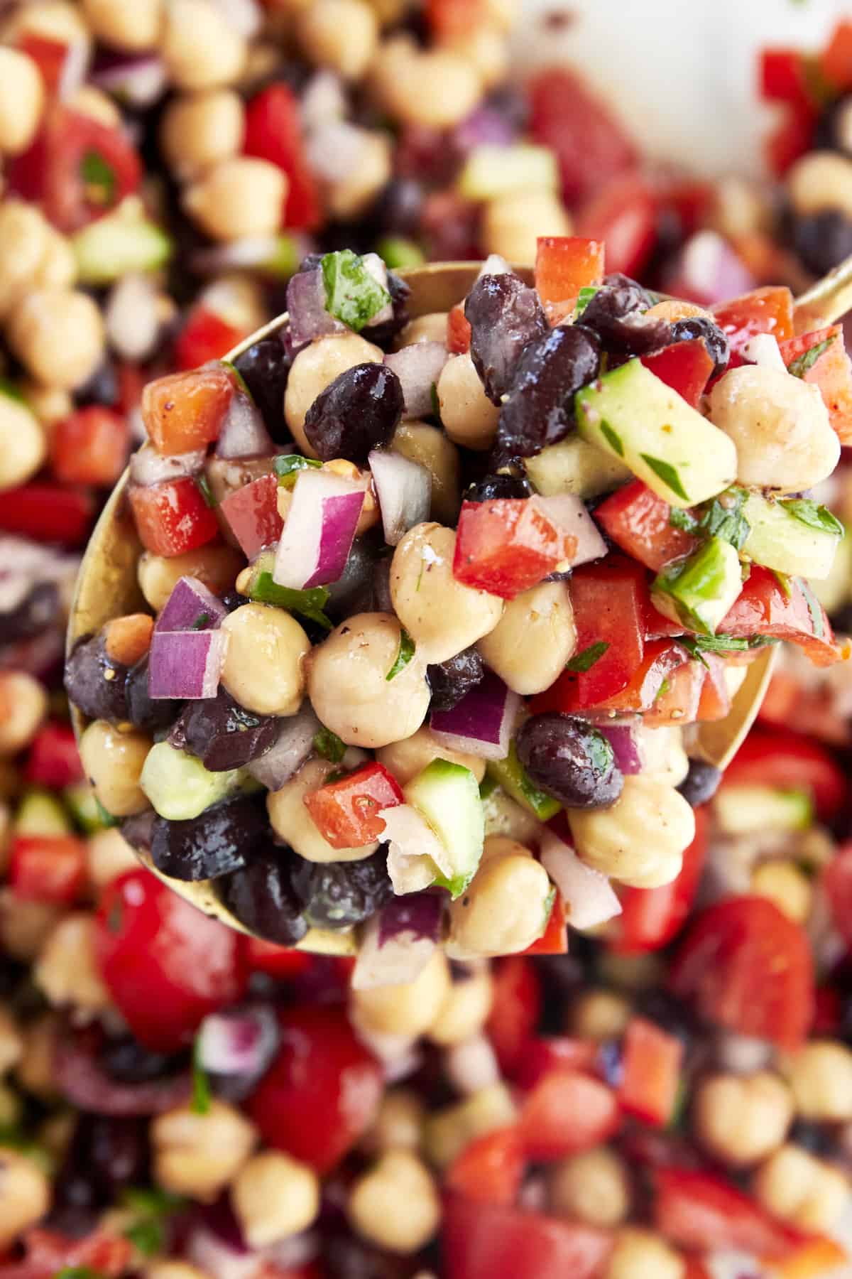 A spoon scooping up a portion of Balela Salad.