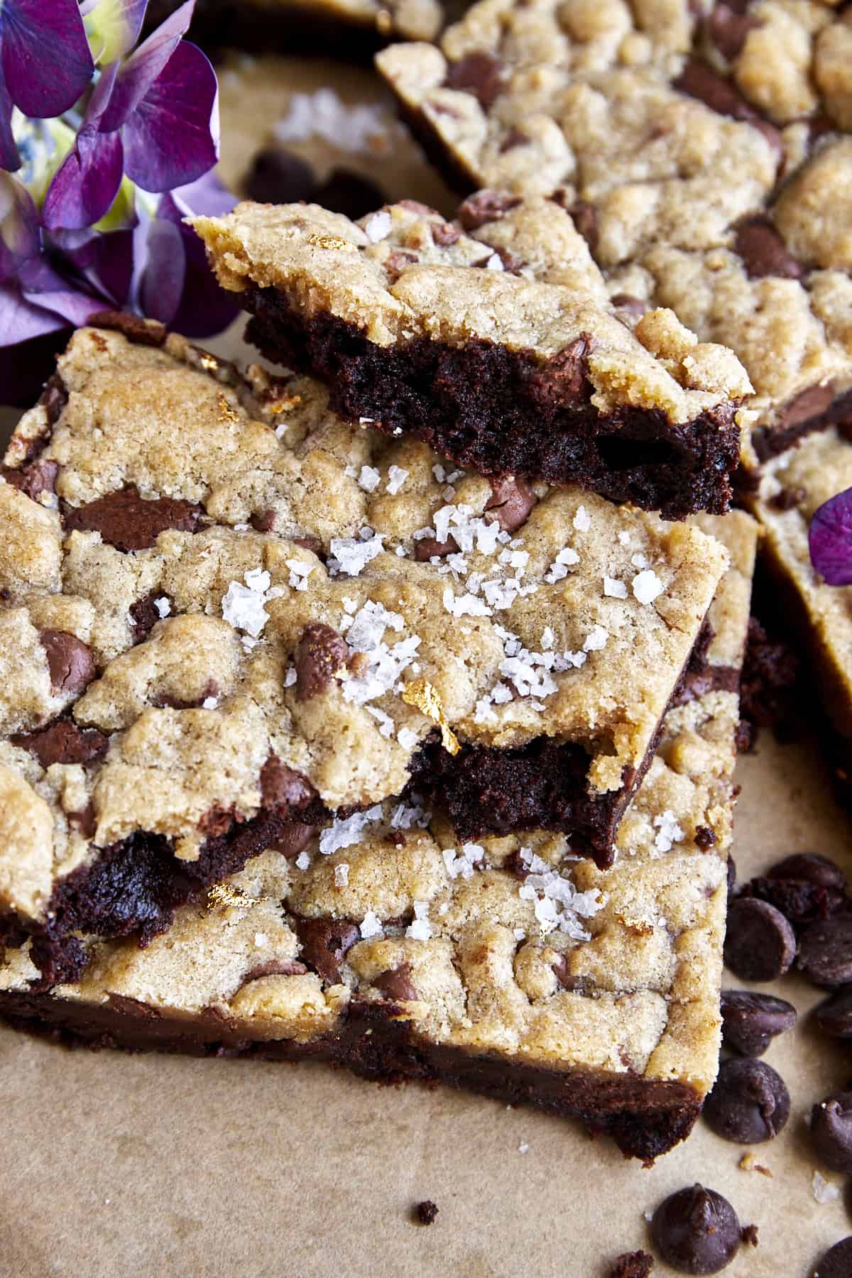 A stack of brookie bars with a bite missing out of one.