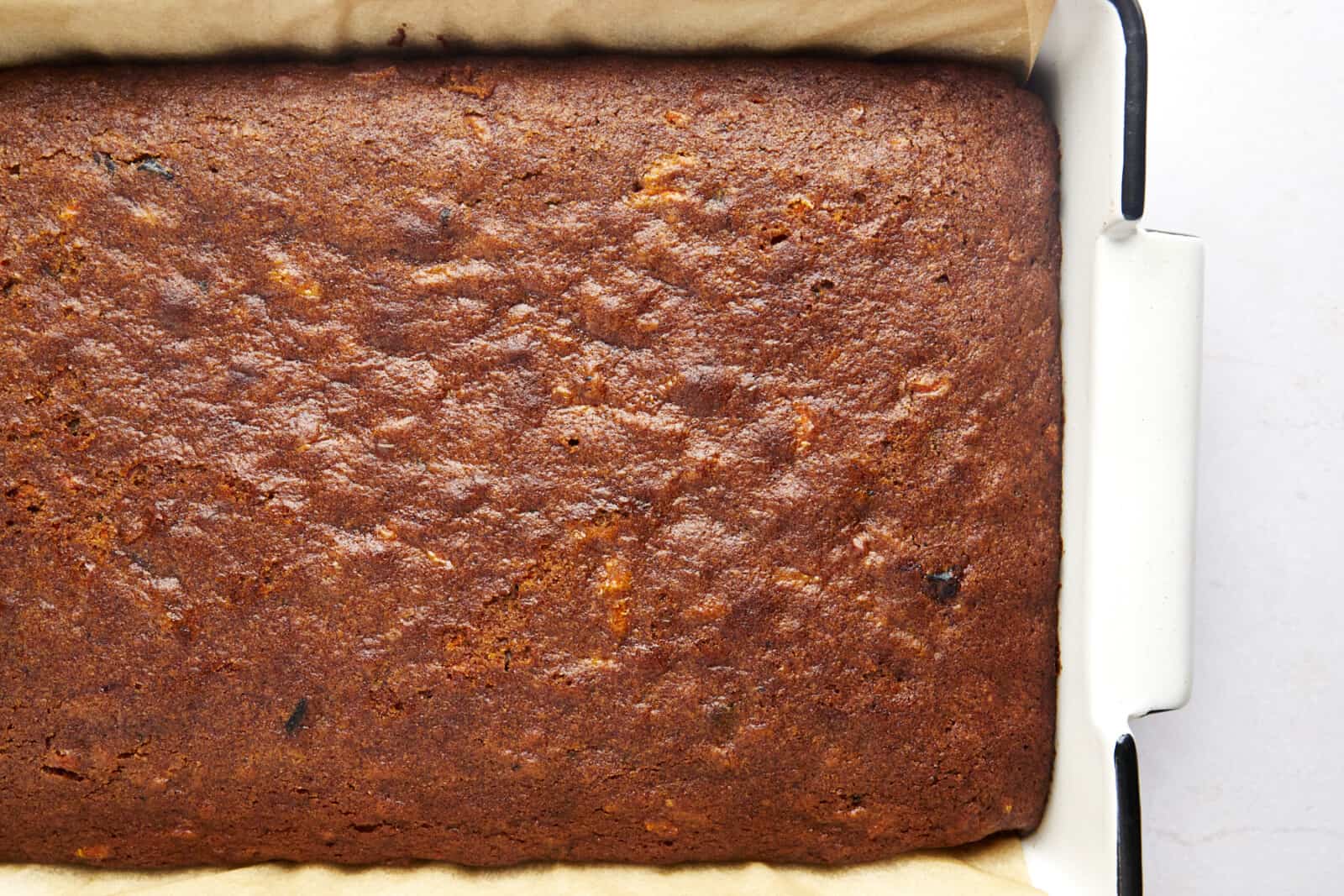 Overhead image of baked carrot cake in a baking pan. 