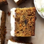 Side view of a piece of easy carrot cake topped with cream cheese frosting.