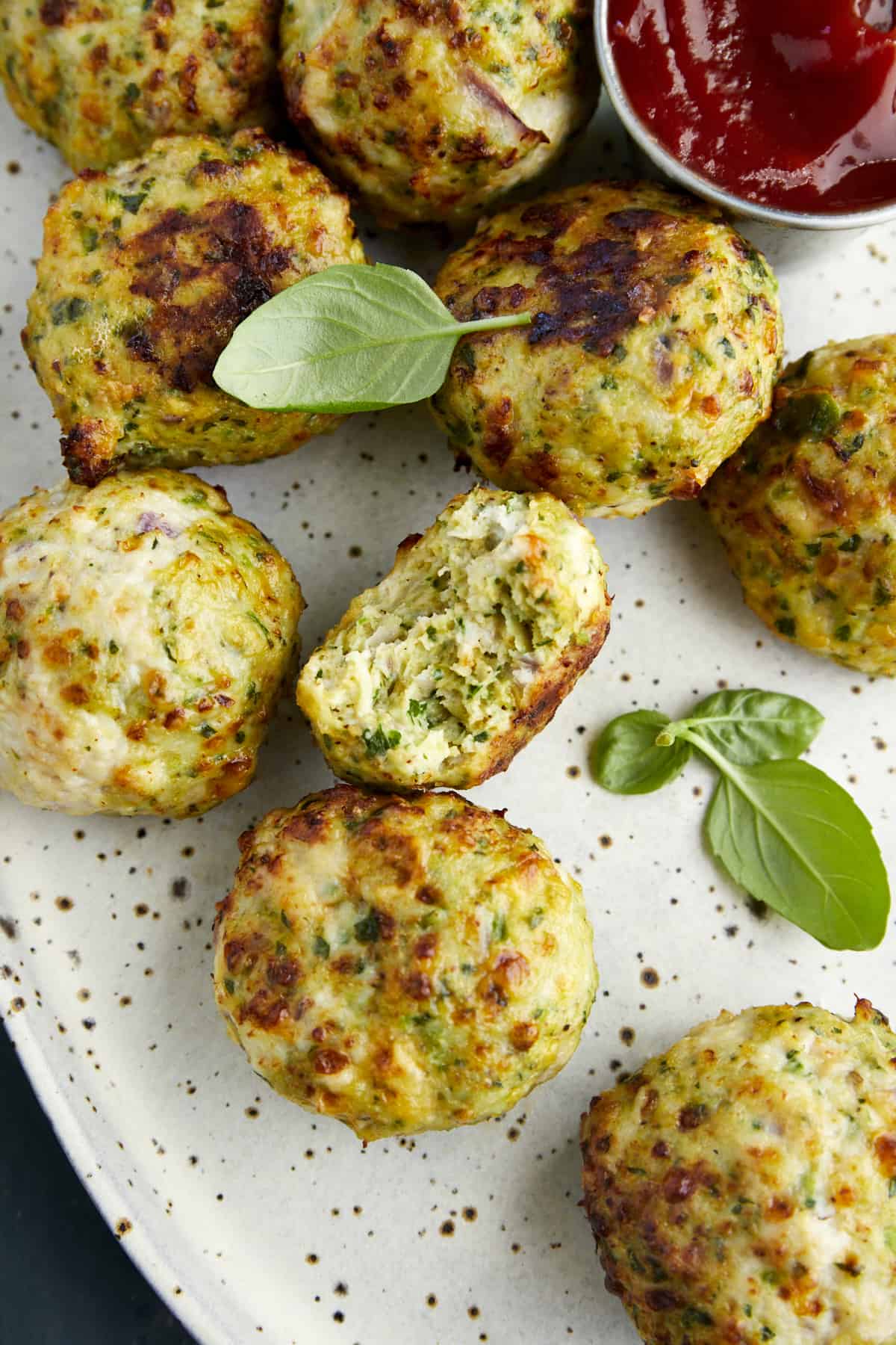 Air Fryer Jalapeño Cheddar Chicken Meatballs with a bite taken out of one. 