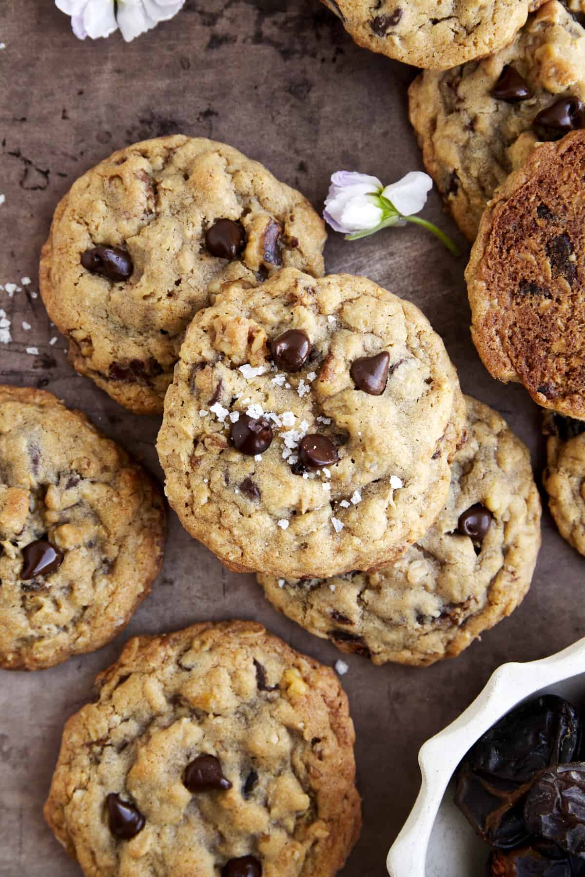 Overhead image of baked Date Cookies with chocolate chips and walnuts topped with sea salt.