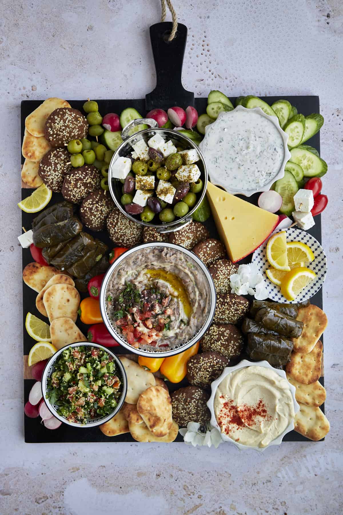 Overhead image of a Mediterranean Mezze Platter with dips, spreads, falafel, pita, veggies, and more. 