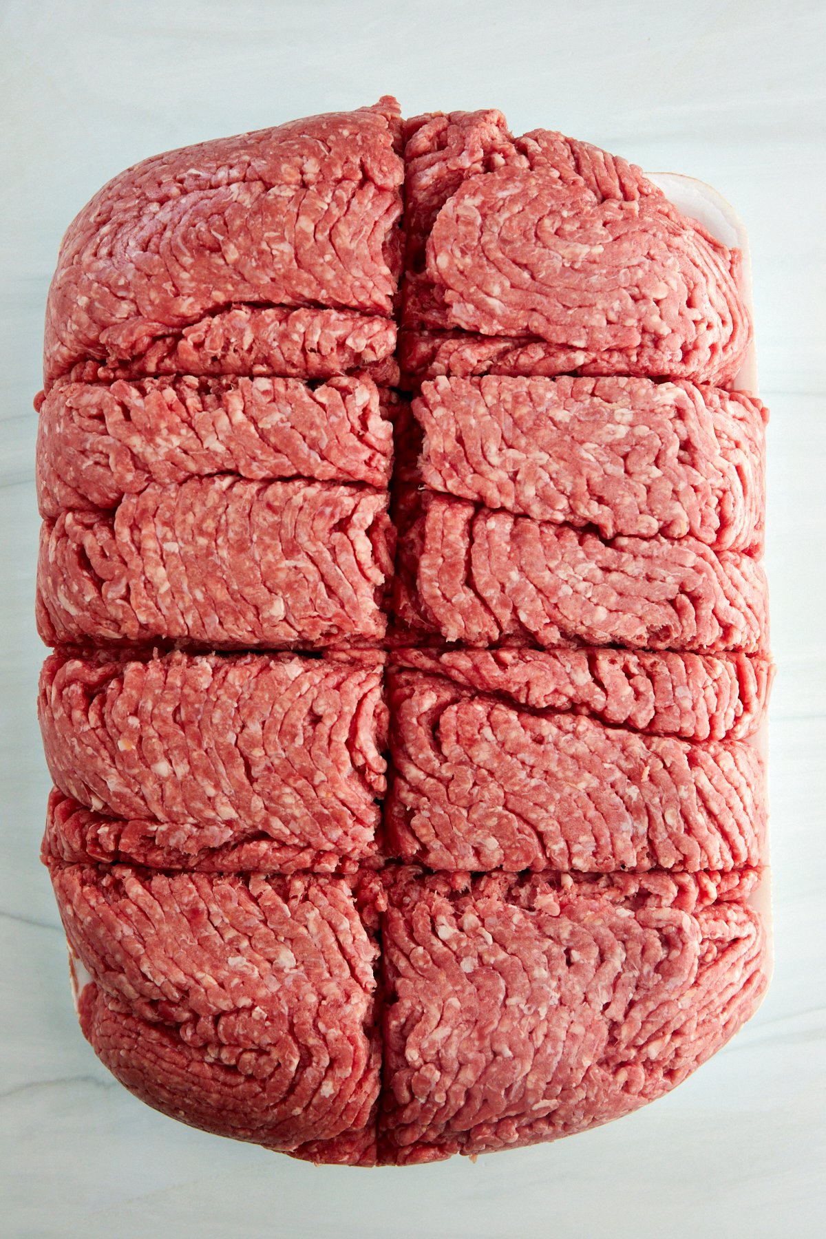 Raw ground beef sectioned into 1 pound portions. 