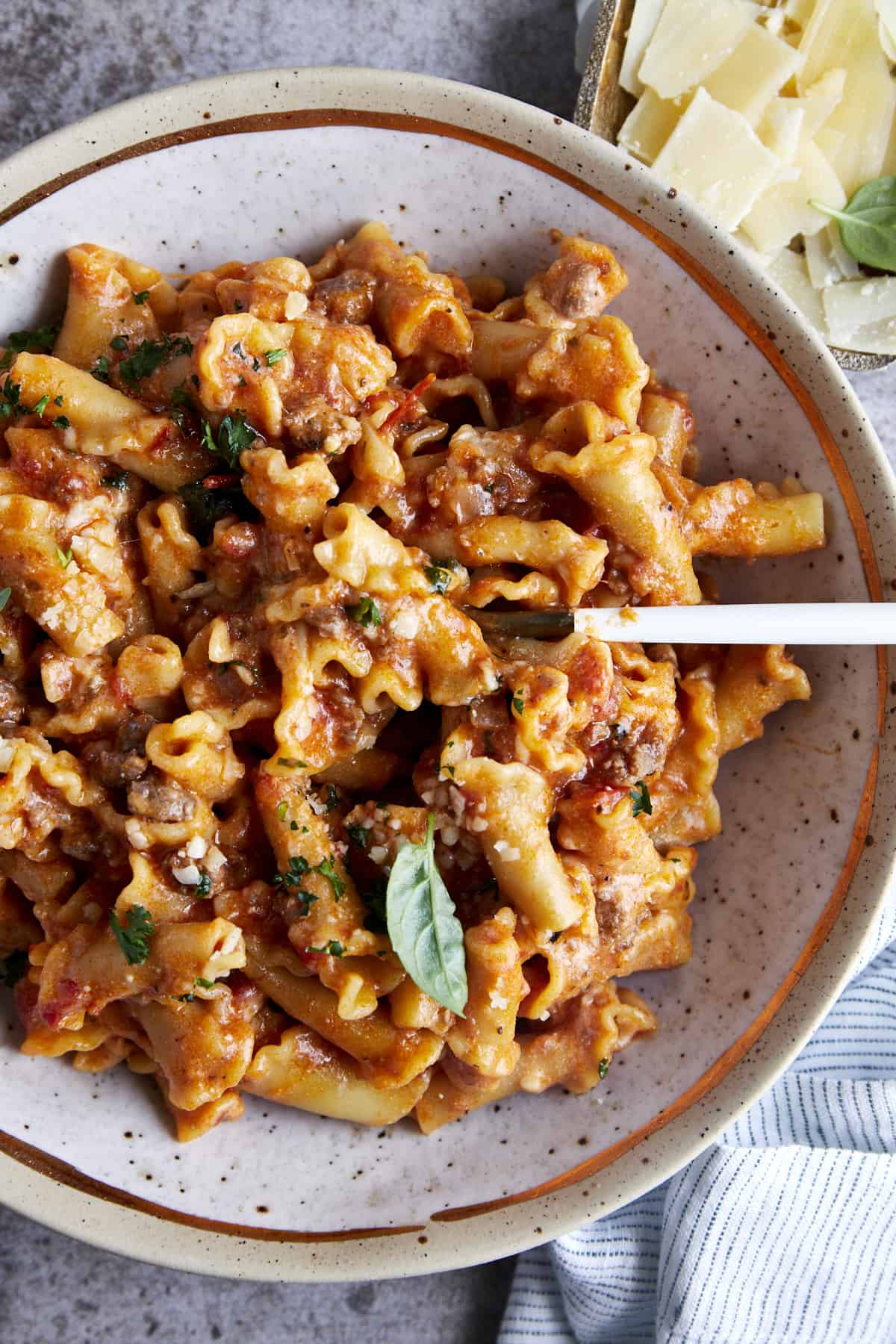 Overhead image of a bowl of one pot lasagna pasta with a spoon sticking out. 