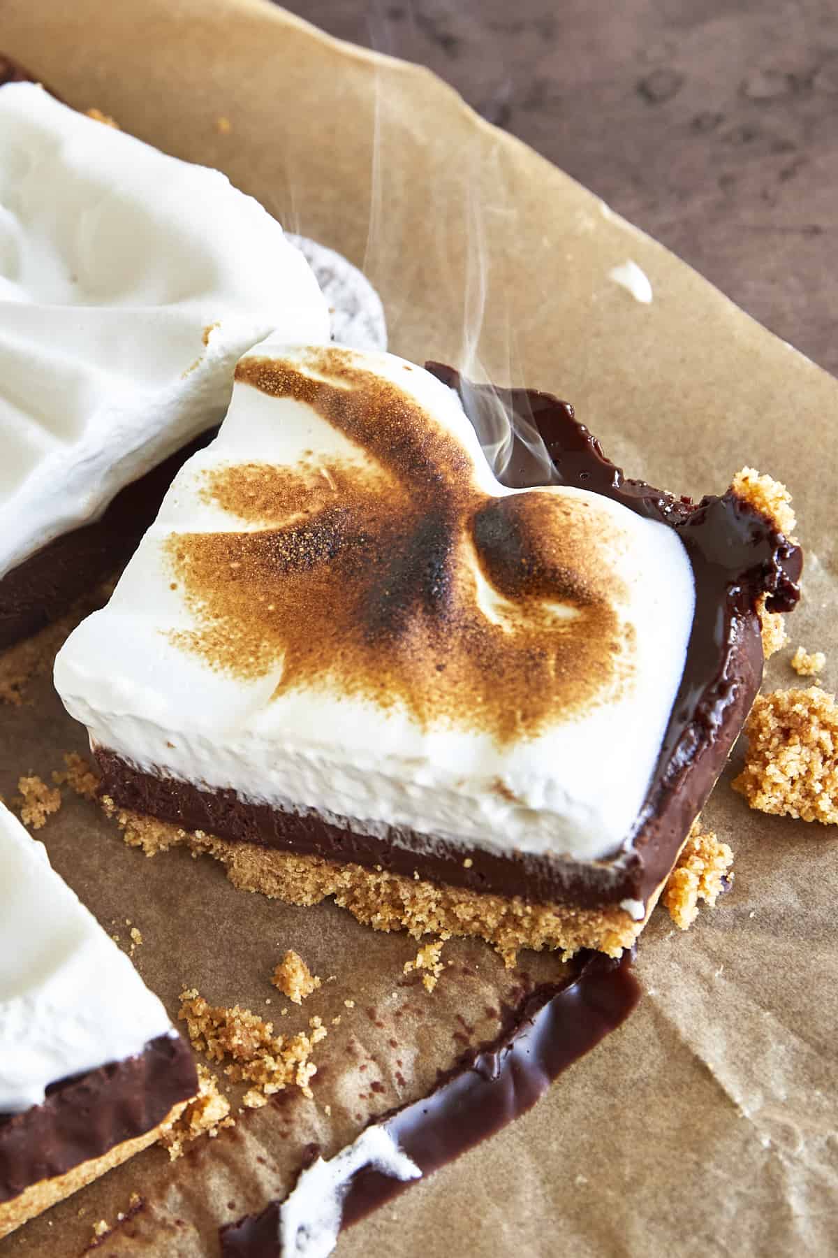 A s'mores bar smoking from being torched with a blow torch. 