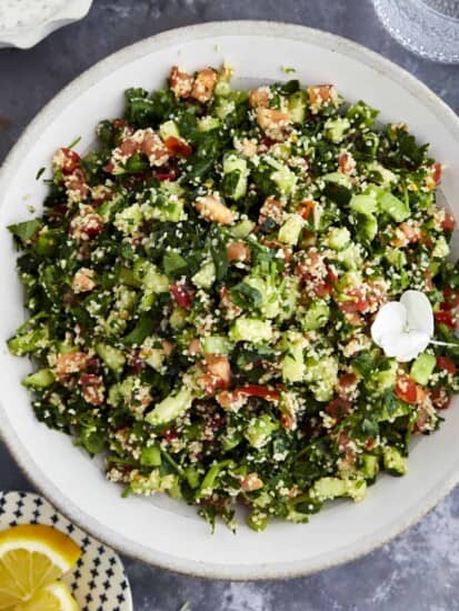 A bowl of tabbouleh salad with fresh herbs, veggies, and bulgur wheat.