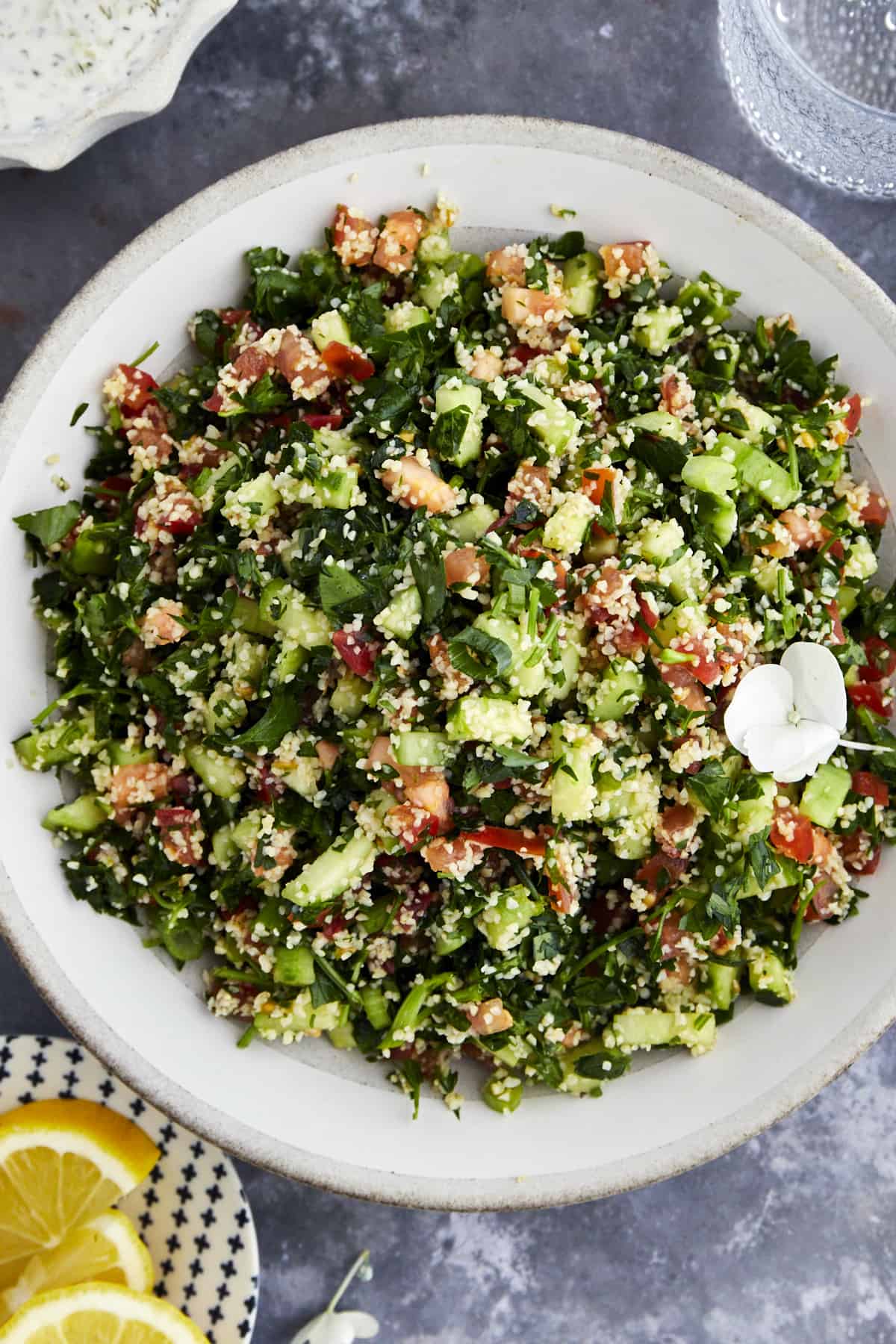 A bowl of tabbouleh salad with fresh herbs, veggies, and bulgur wheat.