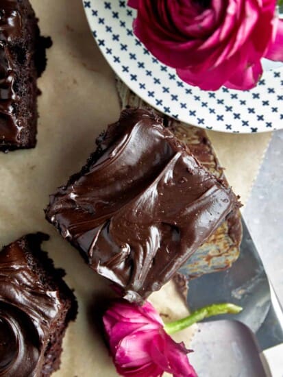 A square of chocolate zucchini cake topped with chocolate frosting.